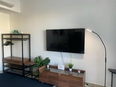 a living room with a flat screen tv on a wall at Contemporary Condo Studio in G-Cribs in El Gouna