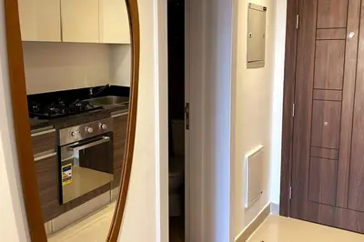 a mirror in a kitchen with a stove and a oven at Contemporary Condo Studio in G-Cribs in El Gouna