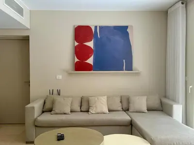 a living room with a couch and a table at Bright 1BR Apt - Free Beach And Pool In Mangroovy ElGouna in Hurghada