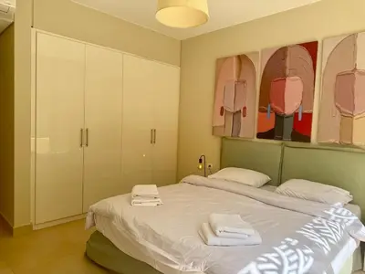 a bedroom with a bed with towels on it at Bright 1BR Apt - Free Beach And Pool In Mangroovy ElGouna in Hurghada
