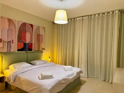 a bedroom with a bed with two towels on it at Bright 1BR Apt - Free Beach And Pool In Mangroovy ElGouna in Hurghada