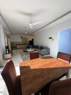 a living room with a table and a couch at Al Baba II Nile Villa in Luxor