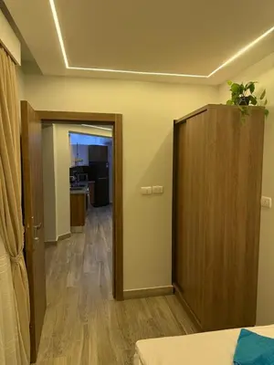 a room with a bed and a cabinet and a hallway at Private Rooftop Two Bedroom SeaView Panorama in Hurghada