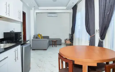a kitchen and living room with a table and a couch at Juliana beach resort by V in Hurghada