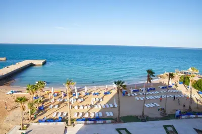 an aerial view of a beach with chairs and the ocean at Juliana beach resort by V in Hurghada