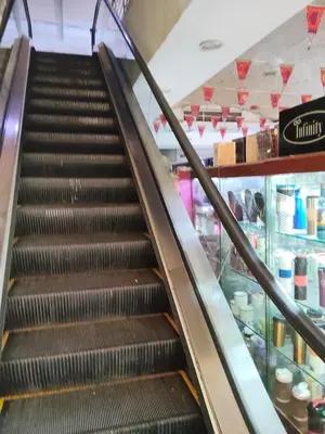 an escalator in a store with a food counter at شقة بمول اسوان بلازا- اسوان in Aswān