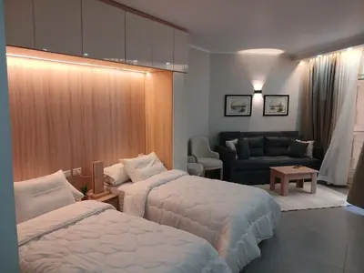 a hotel room with two beds and a couch at فندق ومنتجع سكاندك in Hurghada