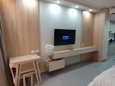 a bedroom with a tv on a wall at فندق ومنتجع سكاندك in Hurghada
