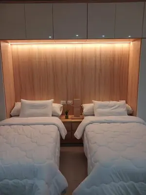 two twin beds in a room with a wall at فندق ومنتجع سكاندك in Hurghada