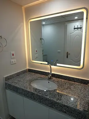a bathroom with a sink and a mirror at فندق ومنتجع سكاندك in Hurghada