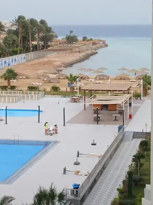 an aerial view of the beach and swimming pool at a resort at فندق ومنتجع سكاندك in Hurghada