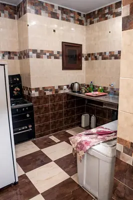 a kitchen with a sink and a counter in a room at المحكمة in Aswan