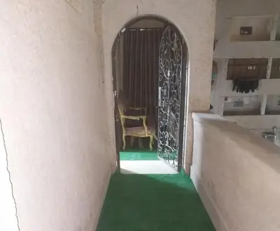 a room with green carpet and a door with a chair at شقة سكنية كبيرة in Aswan