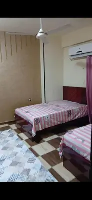 a room with two beds in a room at قصر الحجر in Aswan