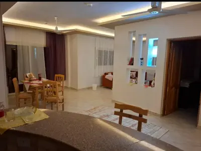 a living room with a table and a dining room at Villa Azad Elkber in Quseir