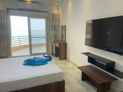 a hotel room with a bed and a large television at مصر in Hurghada