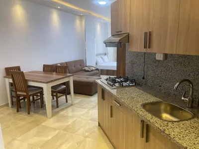 a kitchen and living room with a table and a couch at مصر in Hurghada
