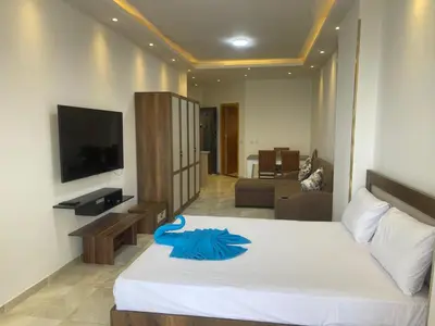 a bedroom with a bed with a blue robe on it at مصر in Hurghada
