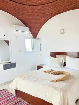 a bedroom with a bed with a snake on it at Orange guest house in Luxor