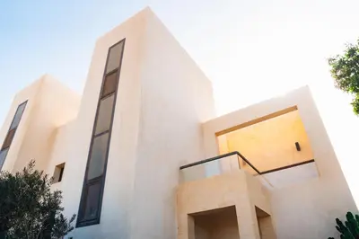 a large white building with a staircase on it at Spacious Lagoon View Villa At Joubal in Hurghada