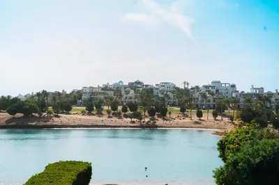 a view of a beach with buildings in the background at Spacious Lagoon View Villa At Joubal in Hurghada