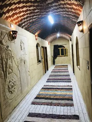 a hallway with a tile ceiling and a hallway with a rug at Labib Guest house in Aswan