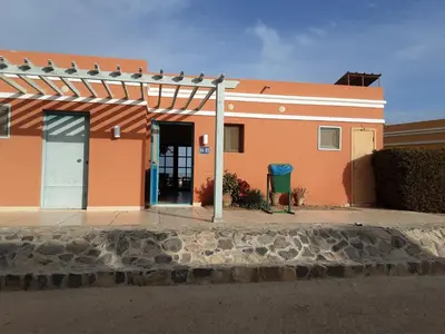 an orange building with a door in front of it at Unique cozy villa sea view in Hurghada