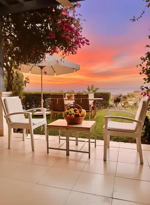 a table and chairs with a bowl of fruit on a patio at Unique cozy villa sea view in Hurghada