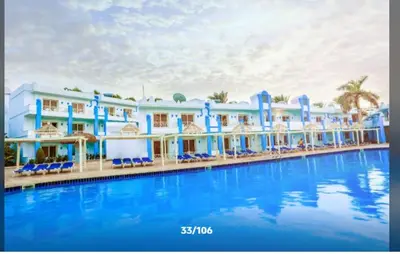 a resort with a large swimming pool in front of it at قرية ميراج باي للراحة والانسجام in Hurghada