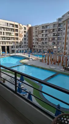 a view of two swimming pools from a balcony at Holiday appartment in Tiba Golden in Hurghada