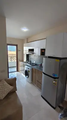 a kitchen with a refrigerator and a stove at Holiday appartment in Tiba Golden in Hurghada