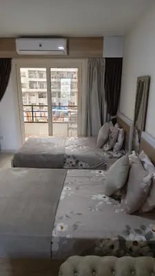 two large beds in a room with a window at Holiday appartment in Tiba Golden in Hurghada