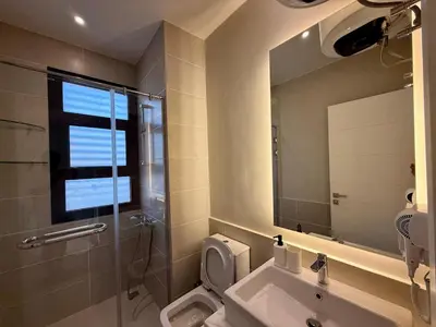 a bathroom with a toilet and a sink and a mirror at Sunny 4BR Villa Plus Nanny With Private Heated Pool And Jacuzzi In ElGouna in Hurghada