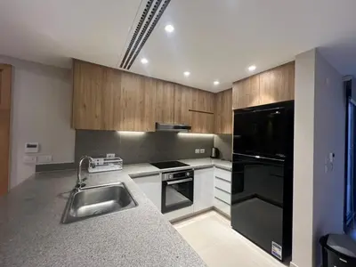 a kitchen with a sink and a black refrigerator at Ancient Hill 3BR Roof & Private Mini Pool in Hurghada