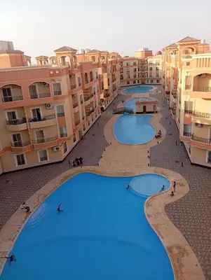 an overhead view of three large pools in a building at Red Ruby suites& flats HRG & Elgouna in El Gouna