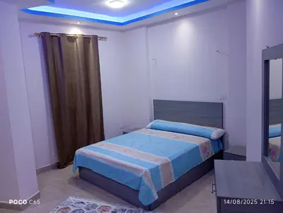 a bedroom with a bed with a blue ceiling at Red Ruby suites& flats HRG & Elgouna in El Gouna