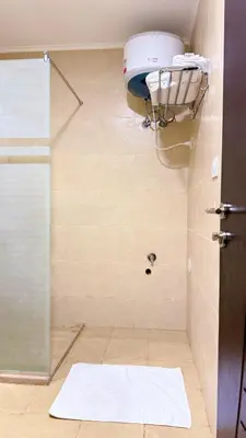 a shower in a bathroom with a glass door at Aldau Heights Hurghada Prestige Spacious Hotel-Style Poolview 1BR in Hurghada