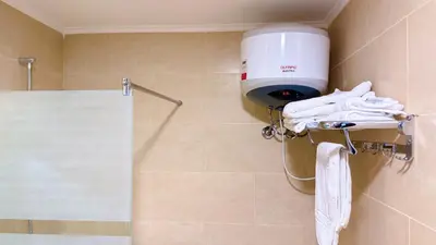 a shower with a blow dryer and towels in a bathroom at Aldau Heights Hurghada Prestige Spacious Hotel-Style Poolview 1BR in Hurghada