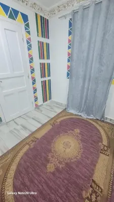 a room with a purple rug and a door at Aladino Nubian Soul in Aswan