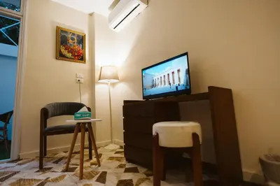 a living room with a tv and a table and chairs at The View Luxor hotel in Luxor