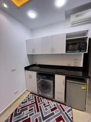 a kitchen with a washing machine and a microwave at Diamond resort Hurghada 7 in Hurghada