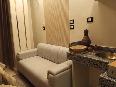 a bathroom with a couch next to a sink at Woori Duri \ud658\ub300\ub97c \uc704\ud574 in Aswan
