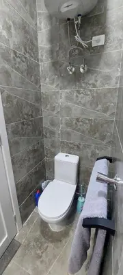 a bathroom with a white toilet and a sink at Relax near the sea, one bedroom flat in Hurghada