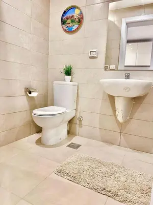 a bathroom with a toilet and a sink at G Grips Grand 4 in El Gouna