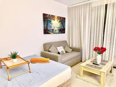 a living room with a bed and a couch at G Grips Grand 4 in El Gouna