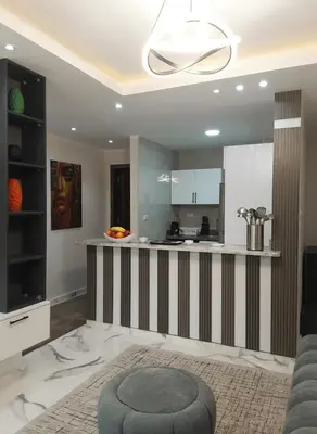 a kitchen with a striped counter and a table at HUB resort Luxury apartment on the pool in Hurghada