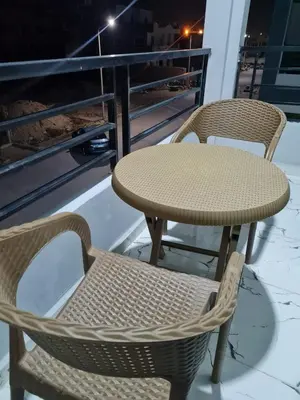 a table and chairs on a balcony at night at La Bellal Star Hurghada A103 in Hurghada