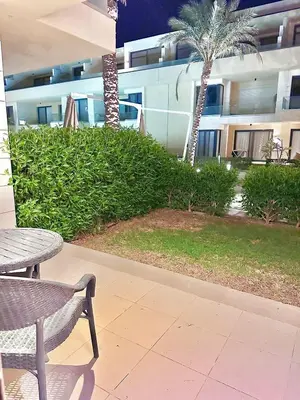 a patio with a table and a chair and a building at El Gouna in Hurghada