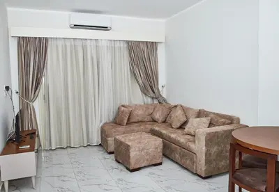 a living room with a couch and a table at Juliana beach luxury family suites in Hurghada