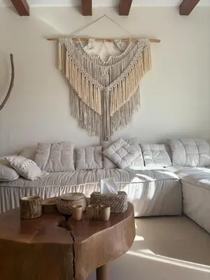 a living room with a couch and a table at Boho El Gouna Shedwan 2BD Beach & Pool Access in Hurghada